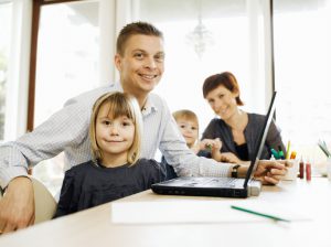 Father and daughter using laptop